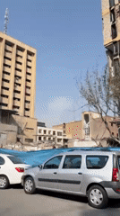 Building debris pile observed behind tarp on Tehran street