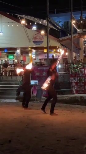 Fire dancers perform coordinated show on Karon Beach