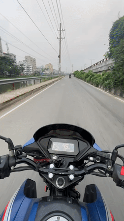 Midnight motorcycle ride through container truck area in Dhaka