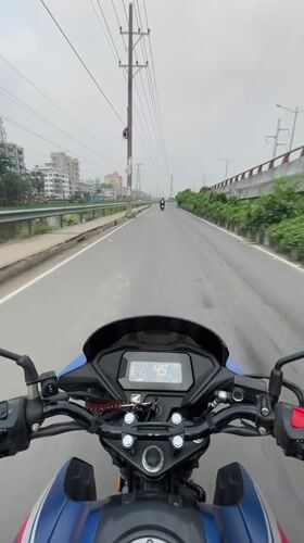 Midnight motorcycle ride through container truck area in Dhaka