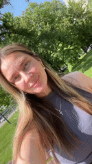 Woman enjoys sunny park moment in Shcherbinka, Russia