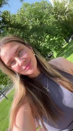 Woman enjoys sunny park moment in Shcherbinka, Russia