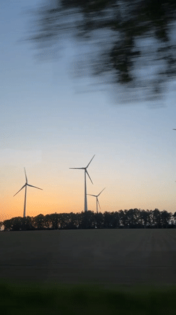 Wind turbines filmed at sunset near Fredenbeck, Germany