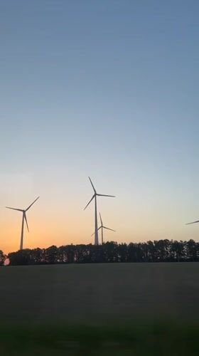 Wind turbines filmed at sunset near Fredenbeck, Germany
