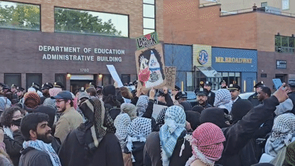 Protesters gather at NYC Education Department building wearing keffiyehs