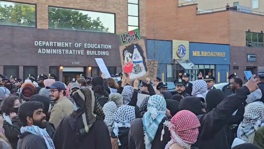 Protesters gather at NYC Education Department building wearing keffiyehs