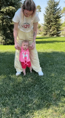 Woman teaches baby to walk in Krasnodar park