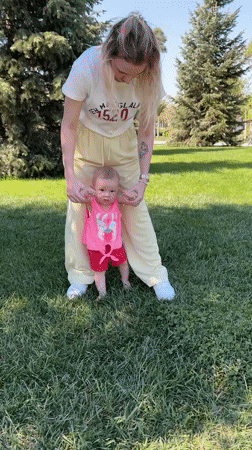 Woman teaches baby to walk in Krasnodar park
