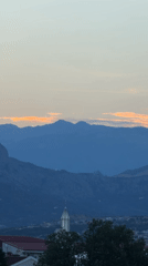 Podgorica at twilight, mountains layered behind the city
