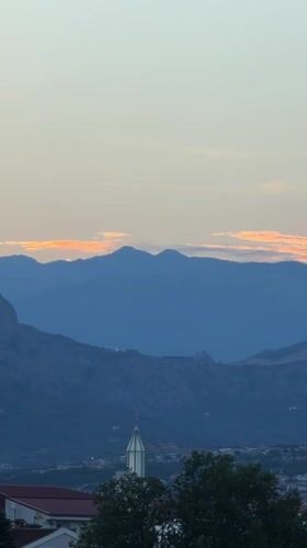 Podgorica at twilight, mountains layered behind the city
