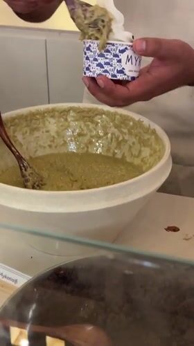 Person serves green-topped frozen yogurt in Puebla, Mexico