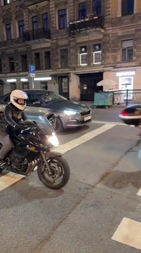 Night traffic around an ornate Saint Petersburg street corner