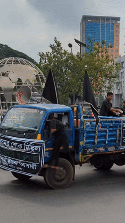 Religious procession with decorated bier and flags through Dhaka streets