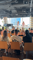Live vocal performance on a Warsaw stage with city skyline backdrop