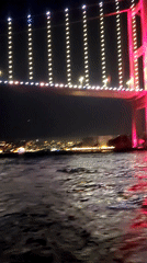Bosphorus Bridge displays pink illumination across Istanbul districts
