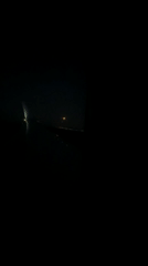 Passenger captures orange moon, city lights during night flight