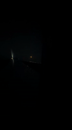 Passenger captures orange moon, city lights during night flight