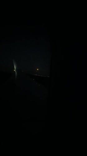 Passenger captures orange moon, city lights during night flight