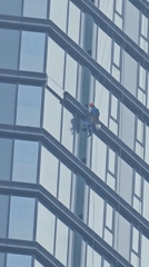 Window washer spotted cleaning Moscow skyscraper exterior