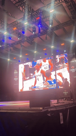 NYC crowd watches basketball on giant outdoor screen