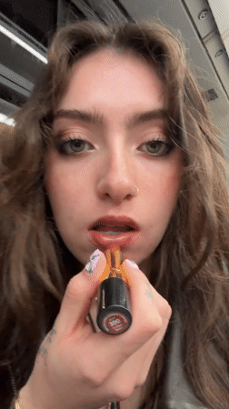 Woman applies lipstick in selfie video, Piano di Sorrento