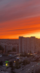 Orange-pink sunset documented over Saint Petersburg urban landscape