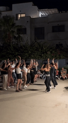 Group of 25 people dance outdoors in Isola delle Femmine