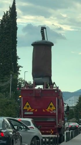 Podgorica street traffic: garbage truck and bus mid-route