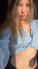 Woman photographed in sunlit indoor selfie session in Russia