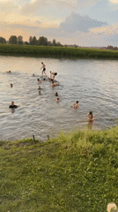 Summer evening swim in a Siberian river at sunset