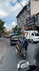 Motorcycle transports ladder through North Kuta streets early morning