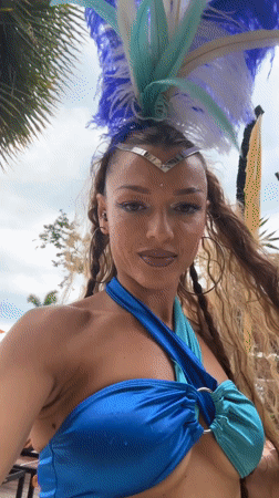 Feathered headdress and bold makeup at Ko Samui beach