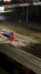 Night road maintenance crew sprays Sofia street