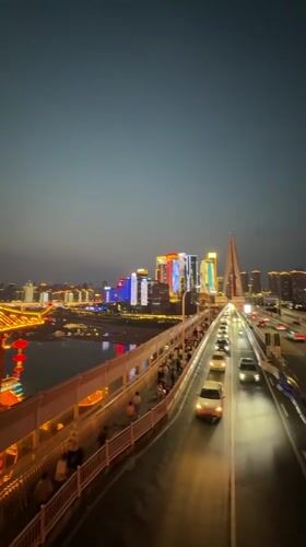 Evening traffic observed on illuminated Yuzhong District bridge