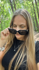 Woman takes selfies in Izhevsk forest during morning photoshoot