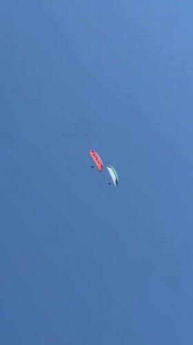 Paragliders over Boreti beach, drinks in hand, summer in full swing