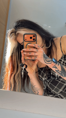Woman takes mirror selfies in Trebesin, Montenegro
