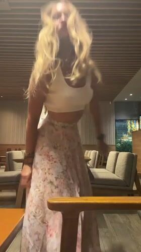 Woman dances at Pattaya Starbucks amid casual cafe atmosphere
