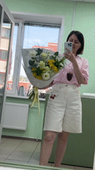 Woman arranges flowers, takes selfies at Izhevsk flower shop