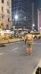Street performers entertain crowds near Buenos Aires Obelisco at night
