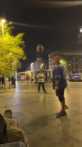 Young people skateboard, play basketball in Barcelona plaza