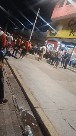 Nighttime gatherings captured outside shops in Juan Griego, Venezuela