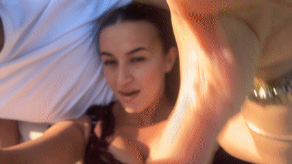 Couple films selfie video while relaxing on grass in London