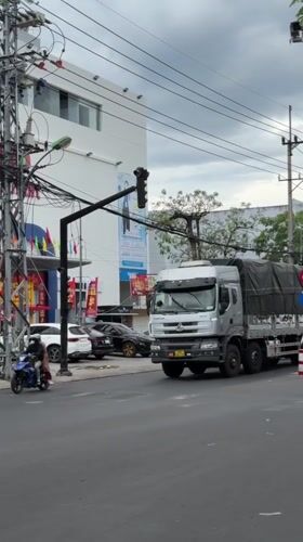 Nha Trang streets on a cloudy weekday morning, commerce and traffic
