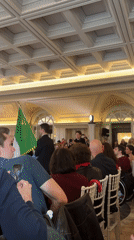 Indoor gathering with seated audience observed in Rome