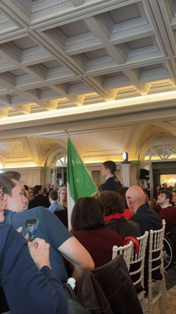 Indoor gathering with seated audience observed in Rome