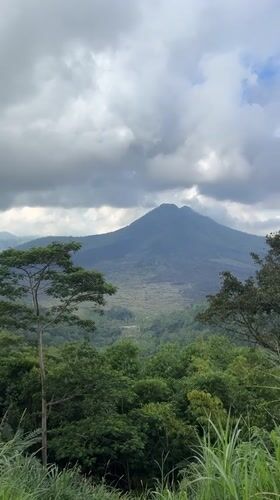 Mount Batur volcano documented under cloudy skies in Kintamani