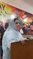 Woman addresses audience at indoor gathering in Quetta