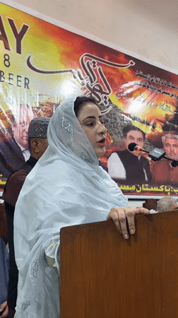 Woman addresses audience at indoor gathering in Quetta