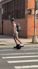 One-wheeling through a New York City intersection in traffic